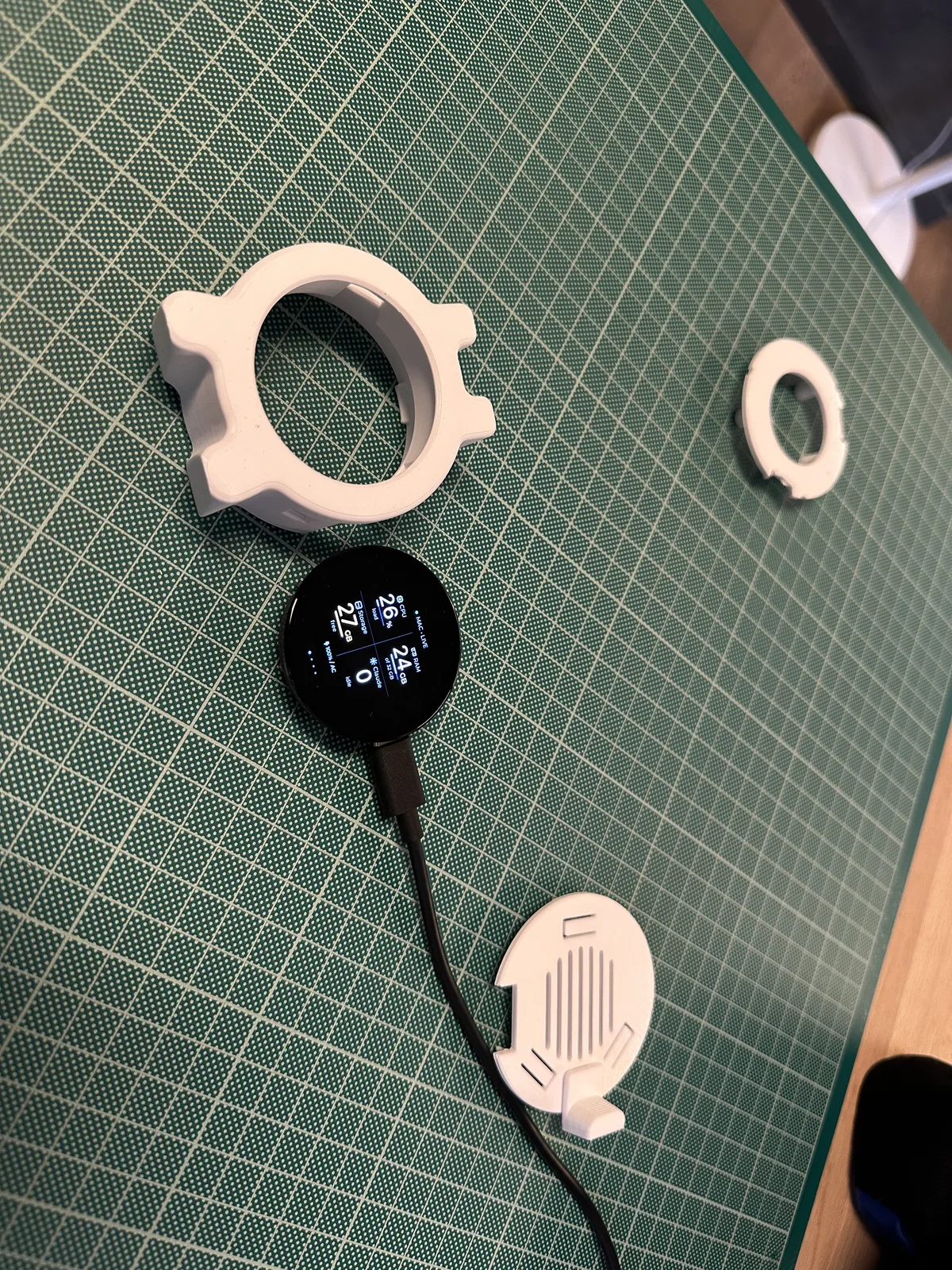 The body, back, frame, and powered display laid out separately on a cutting mat